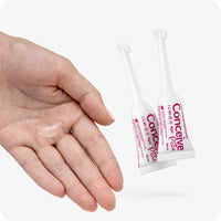 Conceive Plus Fertility Lubricant Pre-Filled Applicators (PT) with two 4g single-use applicators placed next to a female hand displaying a clear portion of the lubricant gel. Designed to support sperm viability with calcium and magnesium ions.