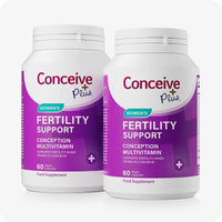 Two bottles of Conceive Plus Women's Fertility Support supplement, each labeled with purple and white branding and containing 60 pink vegan capsules. Promoted as a conception multivitamin for women trying to conceive. Designed to support fertility, hormonal balance, and reproductive health.
